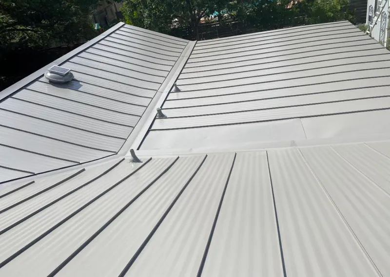 Solar attic fan installed on a metal roof for Roof Ventilation in Montevallo